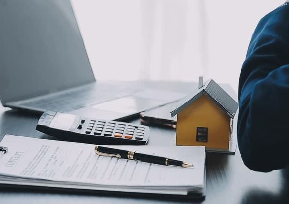 Nigerian investor checking real estate documents to avoid property scams.